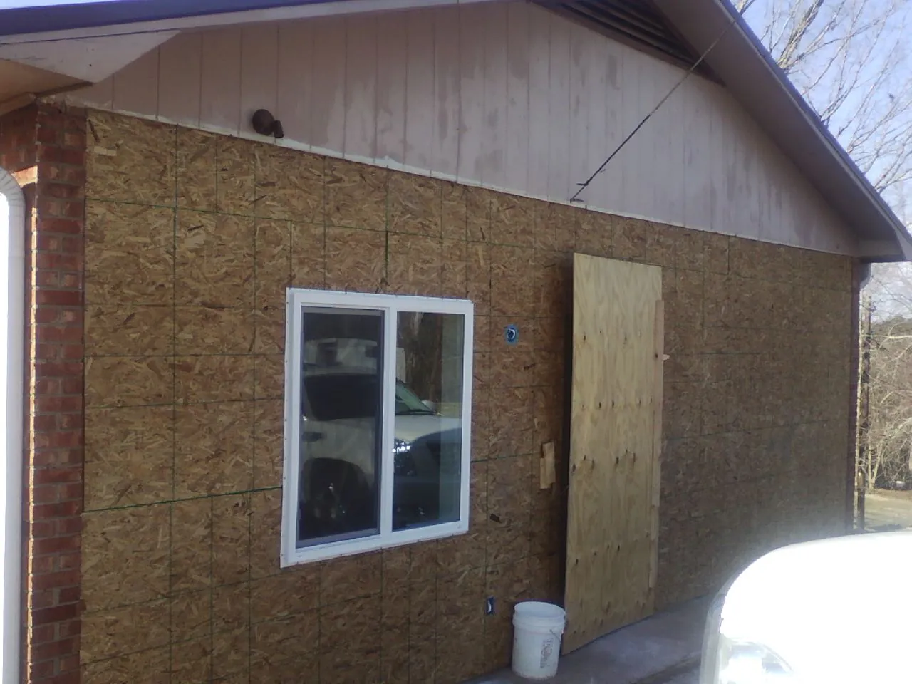 OSB sheathing on a garage addition wall before siding in Albuquerque