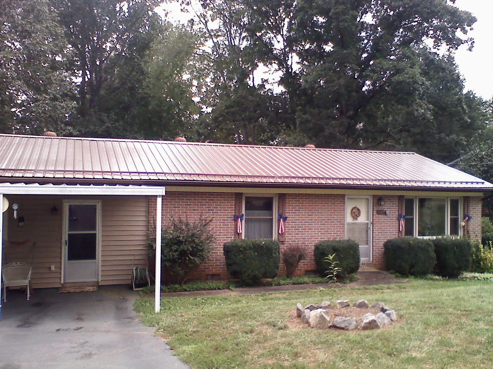 Bronze metal roof and carport on a brick ranch home — Roof Repair work by our crew in Albuquerque