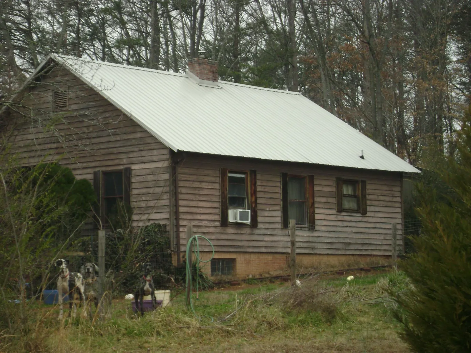 White metal roof on an old wood sided farmhouse, from a Metal Roof Installation job in Albuquerque
